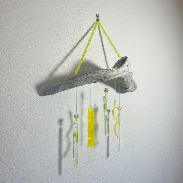 Alaskan Driftwood Chime with Yellow Glass on white background.