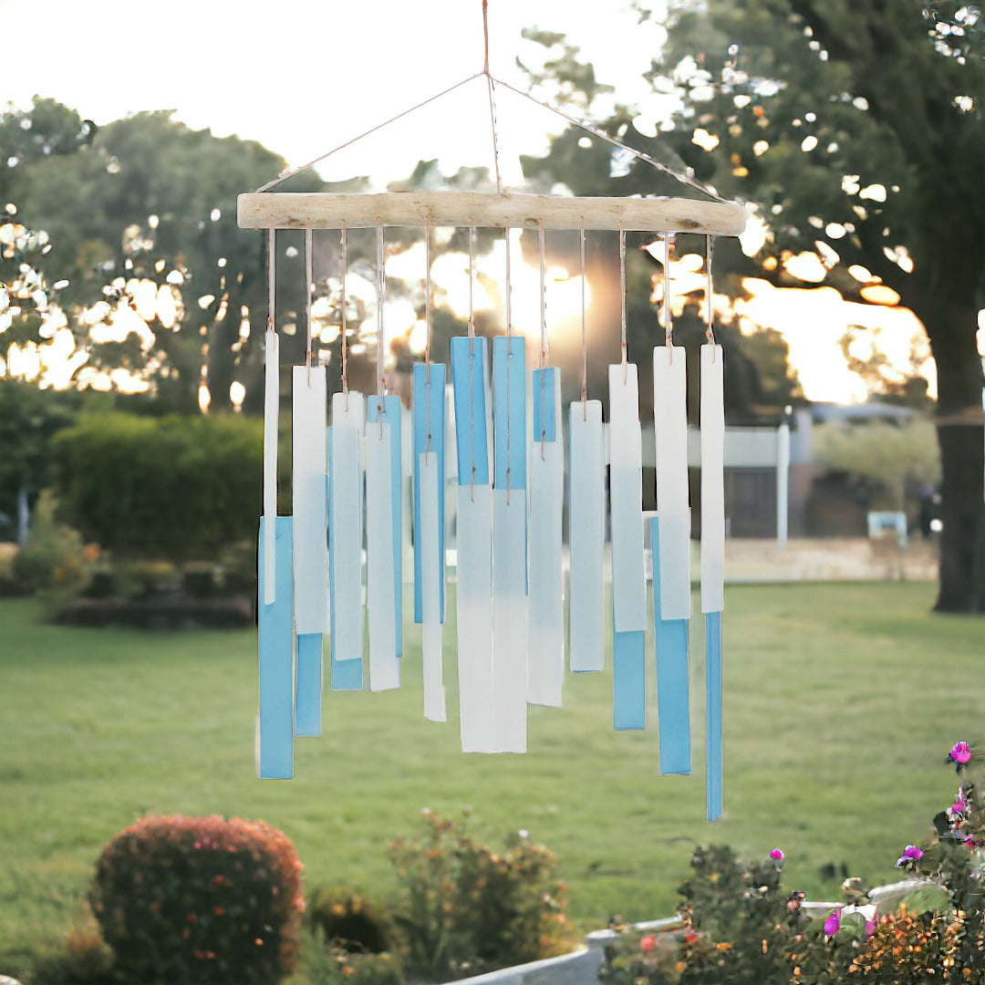 Light Blue and White Skyline Tumbled Glass Wind Chime, front view with garden background 