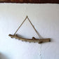 Driftwood Branch Necklace Holder, matte finish. Front view on  white cement background.